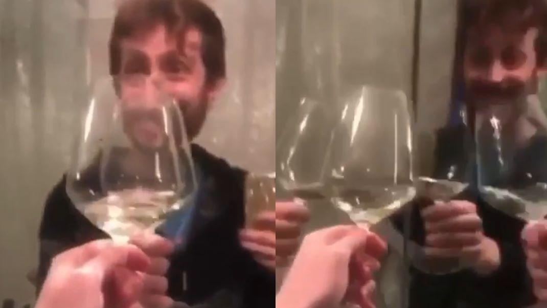 Ανδρας τσουγκρίζει το ποτήρι του σε καθρέφτες 