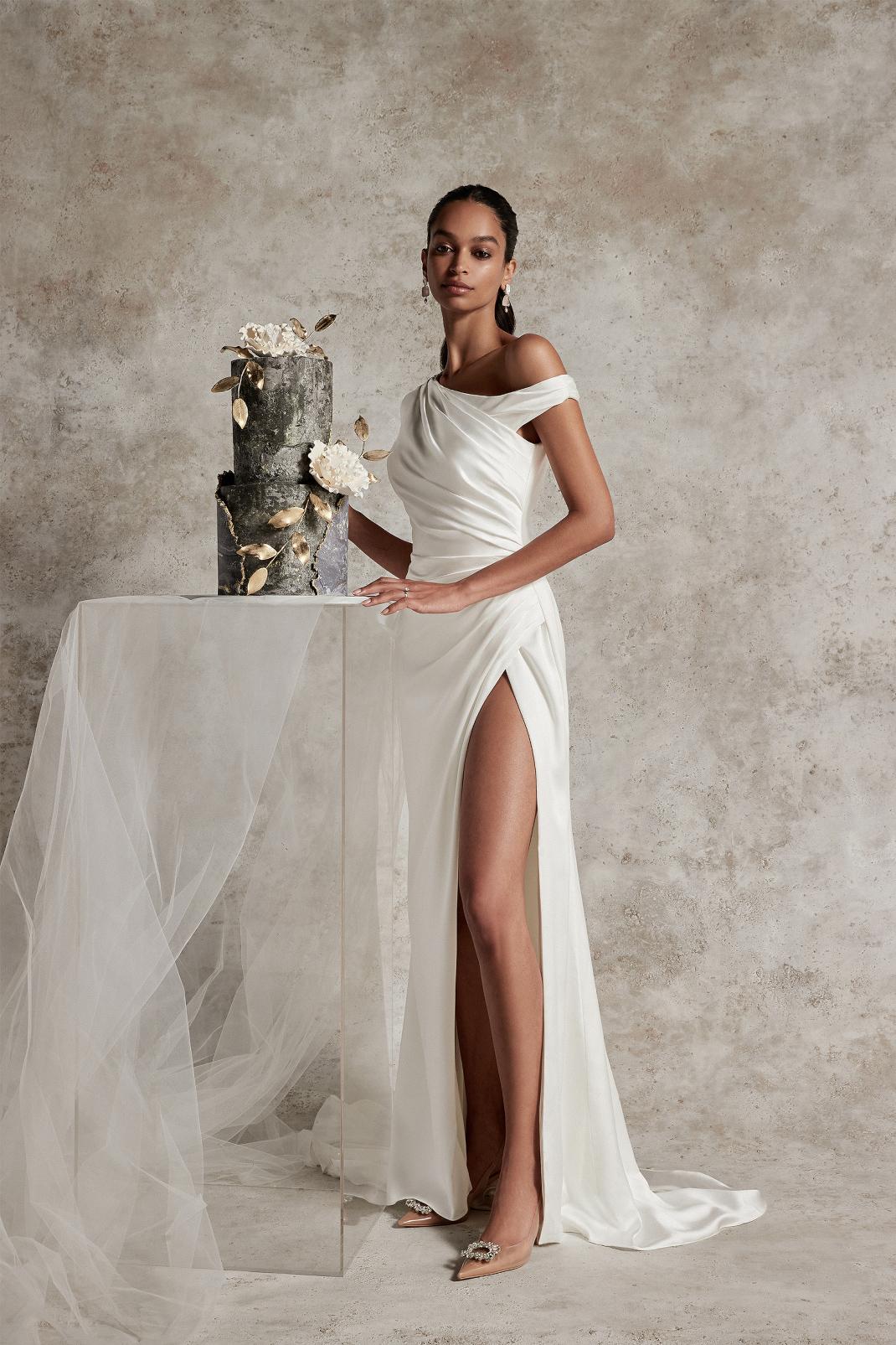 SELENE : CHARMEUSE WEDDING GOWN WITH ASYMMETRIC NECKLINE AND SKIRT SLIT