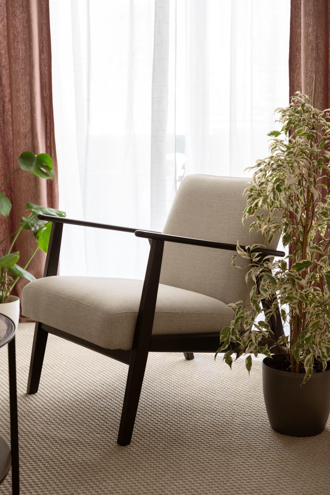 Τα μεγάλα χαλια σε γήινους τόνους καλύπτουν τα υπάρχοντα μπεζ πλακάκια του διαμερίσματος/ Φωτογραφία: Σοφίa Παράσχη 