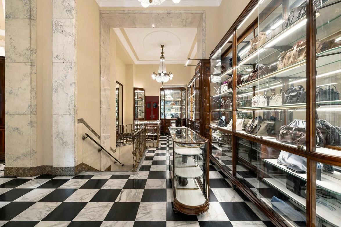 Το εσωτερικό της Prada Galleria συνδυάζει ασπρόμαυρα μαρμάρινα δάπεδα, ξύλινες προθήκες και στοιχεία που παραπέμπουν στην ιστορική ταυτότητα του οίκου./ Courtesy of Prada