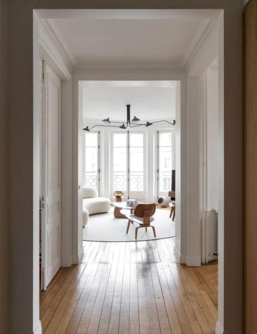 Μετά: Το σαλόνι ξαναβρίσκει την αίγλη του με έναν λιτό συνδυασμό λευκού και ξύλου. Οι βαριές κουρτίνες αντικαταστάθηκαν από ελαφριά υφάσματα για να περνά το φυσικό φως. Τα έπιπλα έγιναν πιο μοντέρνα, με μίνιμαλ οργανικές γραμμές /Φωτογραφία: Elodie Sierocki   