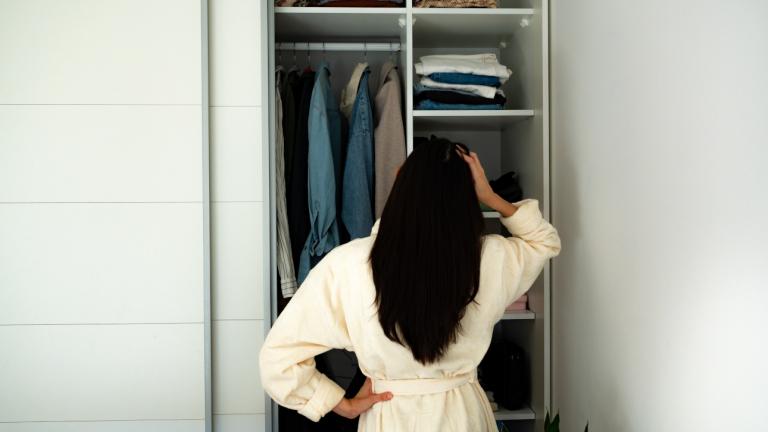 Γυναίκα που κάθεται μπροστά από την ντουλάπα της