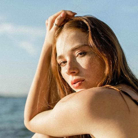 κορίτσι στον ήλιο με φόντο θάλασσα